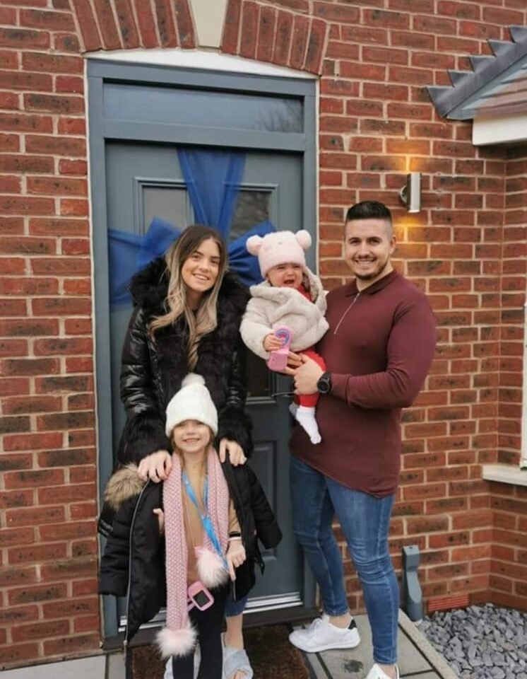 The Crosby family outside of their new house