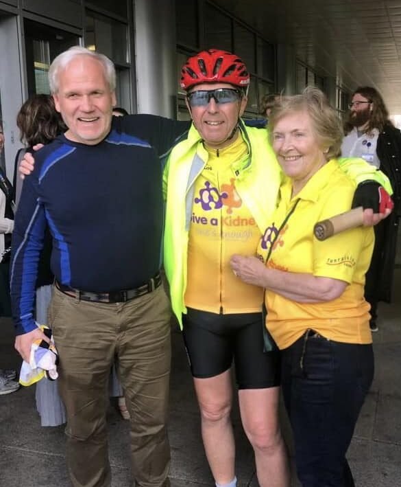 Image of living kidney donor Dennis with two other living kidney donors, all in cycling clothing, smiling at the camera